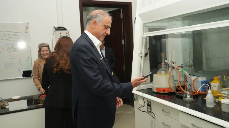 Ambassador Talwar examines UNE's laboratory facilities and equipment